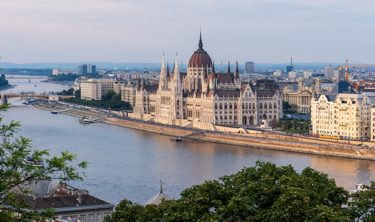 Budapest — brown concrete building near body of water during daytime