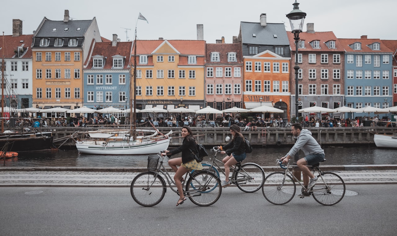 Copenhague — three people riding bicycles