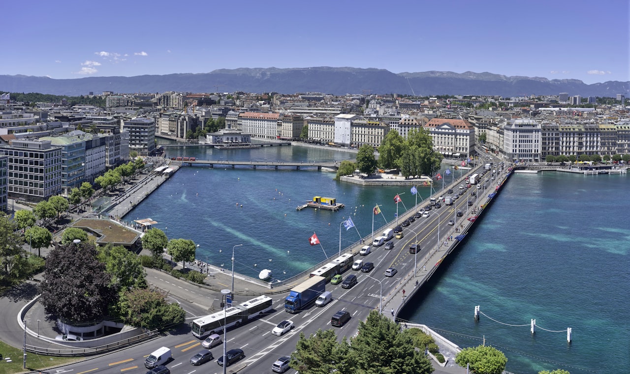 Genève — aerial view of city buildings near body of water during daytime