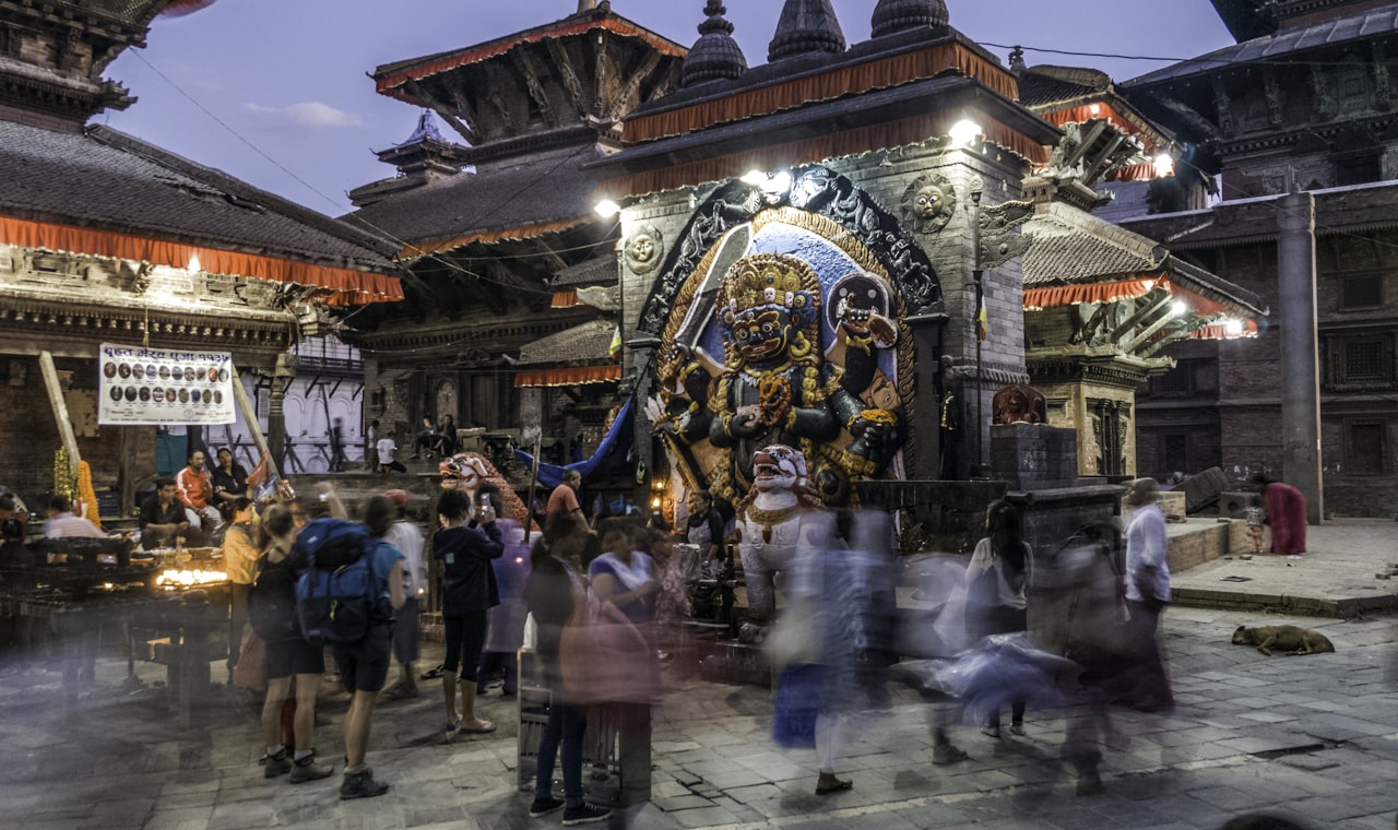 Katmandou — people standing in front of religious statue under blue sky