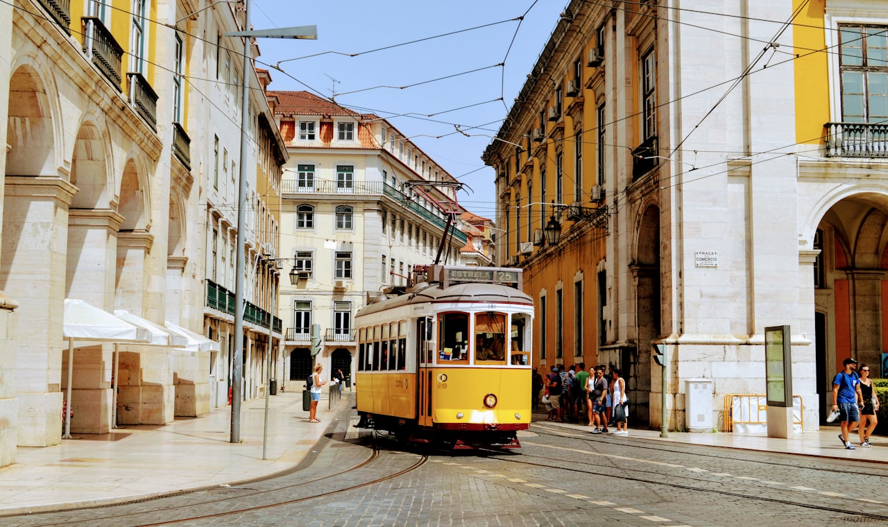 Lisbonne — yellow and white tram on road during daytime
