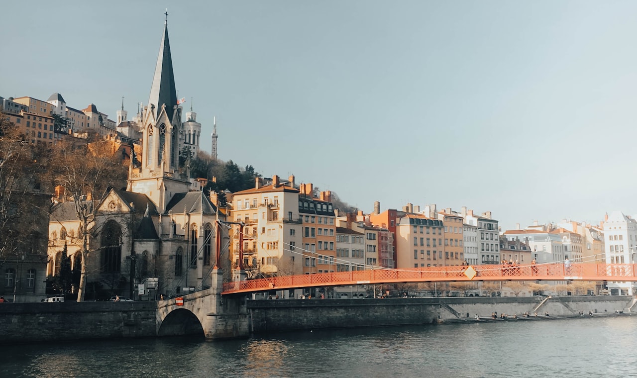 Lyon — brown concrete building near river during daytime