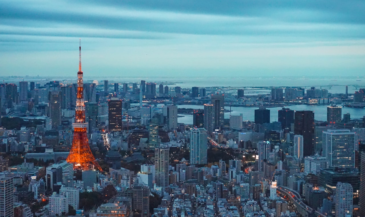 Tokyo — tokyo tower illuminated at dusk with city skyline